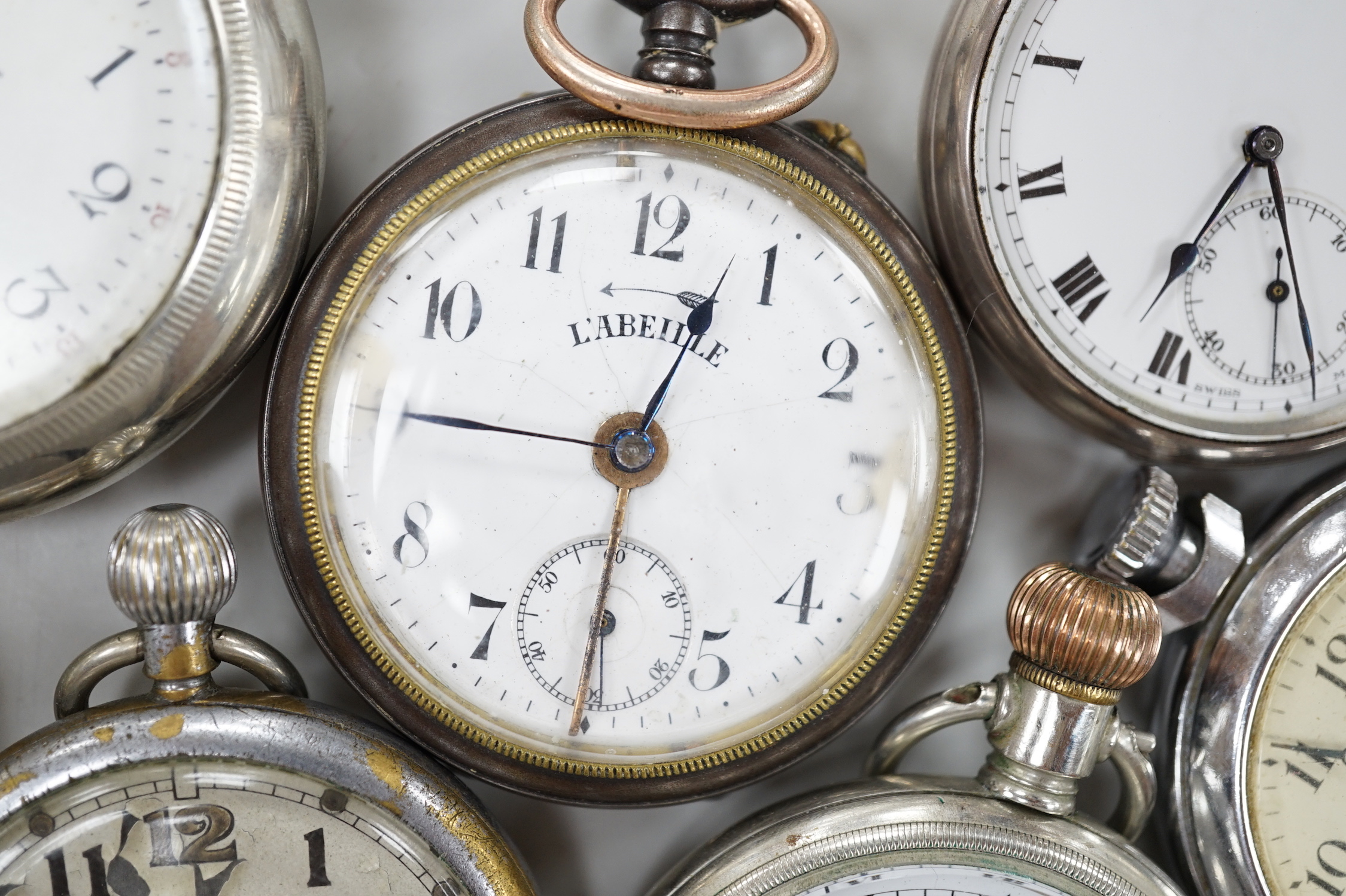 Ten assorted base metal pocket watches including Omega, Waltham and Ingersoll.